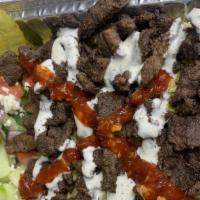 Beef Shawarma Plate · Rice, lettuce, tomato, cucumber, pickle, feta cheese, white sauce, and red sauce.