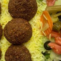 Falafel Plate · Rice, lettuce, tomato, cucumber, pickle, feta cheese, white sauce, and red sauce.