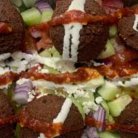 Falafel Salad Plate · lettuce, tomato, cucumber, pickle, feta cheese, white sauce, and red sauce.