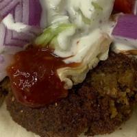 Falafel Wrap · lettuce, tomato, cucumber, pickle ,onion, feta cheese, white sauce, and red sauce