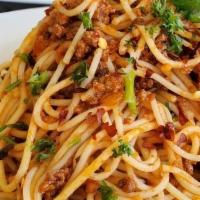 Pasta Bolognese · Red pepper flex, parsley, serve with garlic bread and side Caesar salad.