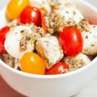 Caprese Salad · Fresh Mozzarella, Tomatoes, Basil, Seasoned with Salt, Black Pepper, Fresh Garlic & Olive Oil