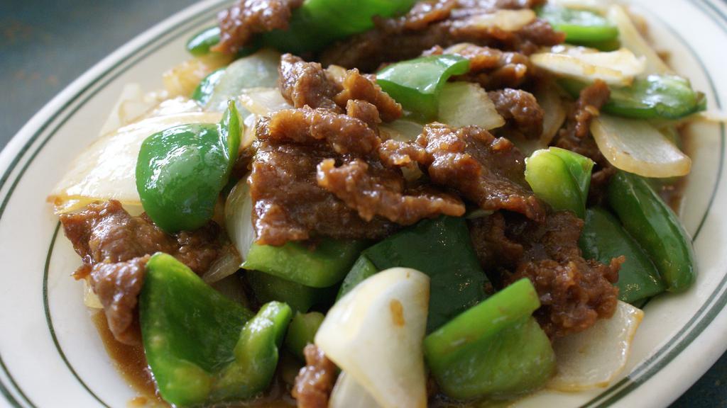 Pepper Steak · With white onions and bell peppers in a brown sauce.