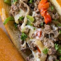 Halal Philly Cheesesteak With Chips And Drink · Thinly sliced halal grilled sirloin steak & bell peppers,  onions topped with melted America...