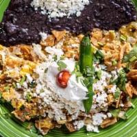 Chilaquiles Plate · Bits of corn tortillas mixed with eggs and green sauce, topped with cheese, onions, cilantro...