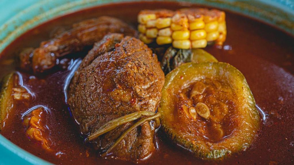 Mole De Olla · Bone-in beef soup cooked with our unique cascabel sauce, zucchini, and corn and cob, served with a side of rice along with two corn tortillas.