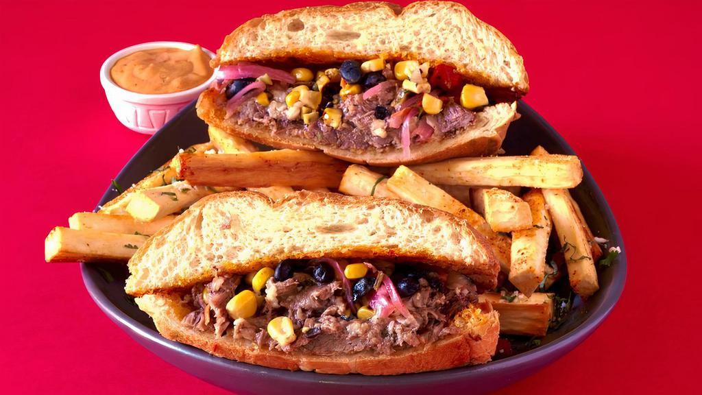 Barbacoa Torta · beer & chile braised beef, black beans, corn pico, pickled red onions