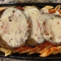 Eggplant Parmesan · Hand breaded eggplant slices with tomato sauce and provolone, oven baked over spaghetti