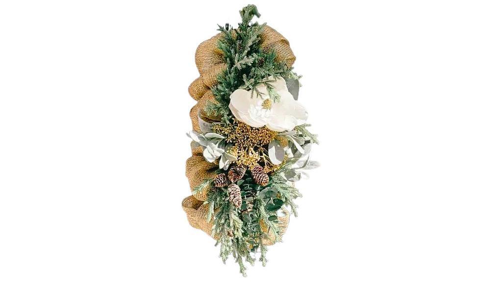 Winter Magnolia & Green Swag (Made To Order) · This medium sized swag is a mix of beautiful winter greens with gold highlights and a large magnolia flower. Beautiful as a table centerpiece or door swag. Lightweight and easy to hang. Faux magnolia flower, faux pine cones and greens, faux lambs ear branches, ribbon and wire hanger, wire and poly pro mesh base and item weighs approximately 2lbs.