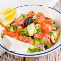 Coban Salad · Fresh diced tomatoes, cucumbers, onions, parsley, lemon juice, olive oil, and feta cheese.