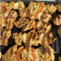 Chicken Shish Kebab · Grilled tender chicken skewered with fresh vegetables. Served with rice, salad, and tzatziki...