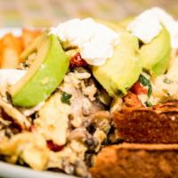 The Favorite · Three eggs scrambled with goat cheese, sun-dried tomatoes, avocados, mushrooms & basil, serv...