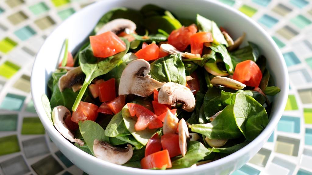 Spinach Salad · Fresh baby spinach, bacon, tomatoes, mushrooms, caramelized pecans & goat cheese tossed with our lemon herb vinaigrette.