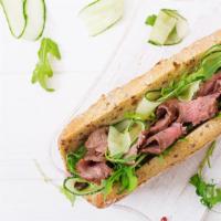 Roast Beef Sandwich · Layers of thinly sliced roast beef topped with fresh lettuce, tomato and onion with deli mus...
