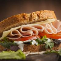 Ham & Turkey Sandwich · Layers of thinly sliced turkey breast and ham topped with fresh lettuce, tomato and onion wi...