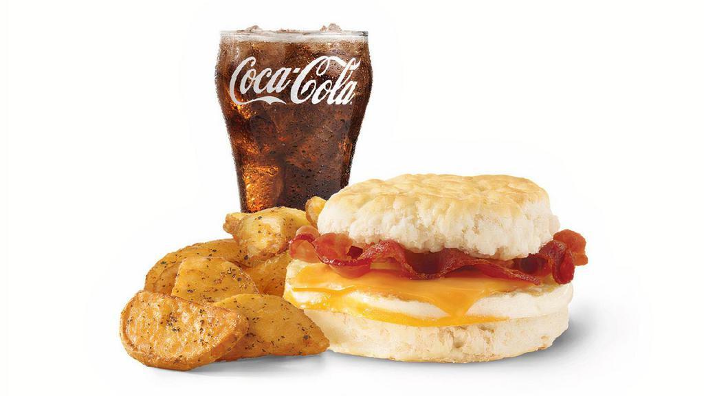 Bacon, Egg & Cheese Biscuit Combo · A fresh-cracked grade A egg on a fluffy buttermilk biscuit with Applewood smoked bacon and melted American cheese. Rise and shine with a hearty favorite.