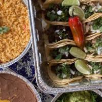 Street Taco Dinner Family Style · Feeds up to 6. Beef and Chicken on stacked corn tortillas topped with diced onions and cilan...