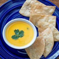 Chile Con Queso - Small · Our house made Chili con Queso, served with Chips & Salsas.