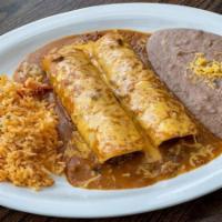 Beef Enchilada Dinner · Two ground beef enchiladas topped with chili gravy and melted cheese. Served with refried be...