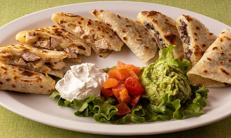 Beef Quesadilla · Grilled Beef & Chicken Quesadillas made with homemade tortillas and melted cheese. Served with diced tomatoes, guacamole, and sour cream.