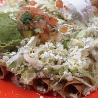Rolled Tacos · Five crispy rolled beef tacos topped with shredded lettuce and cheese. Served with a scoop o...