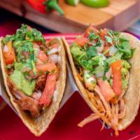 Carnitas Tacos · Two corn tortillas filled with shredded carnitas and topped with salsa fresca and guacamole....