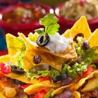 Carnitas Nachos · Classic carnitas nachos with melted cheese, pico de gallo, beans, and your choice of toppings.