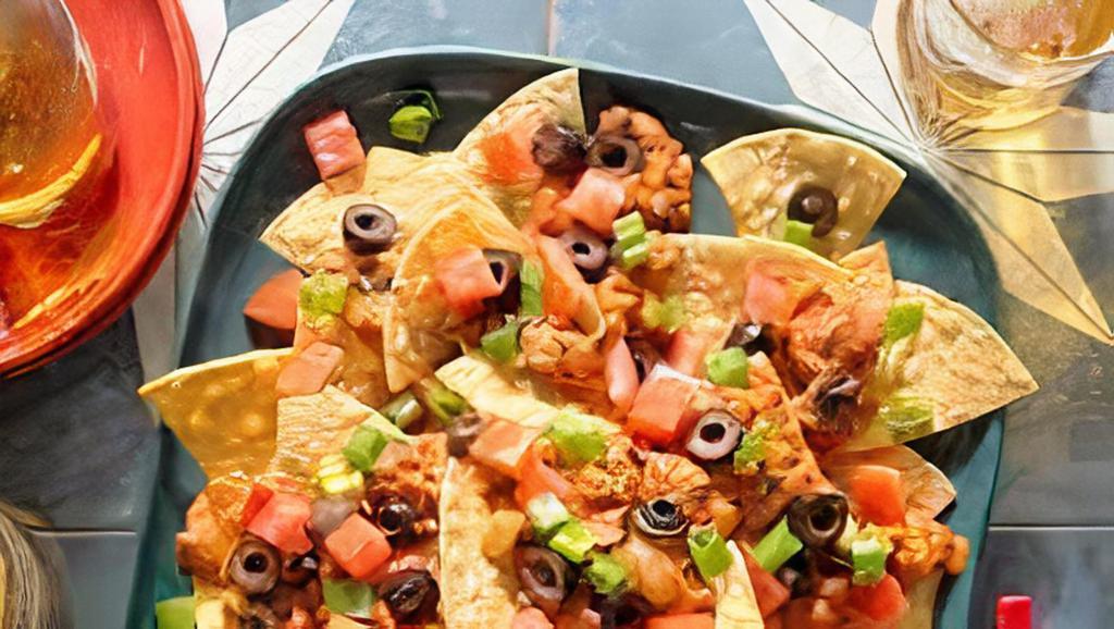 Al Pastor Nachos · Classic al pastor nachos with melted cheese, pico de gallo, beans, and your choice of toppings.