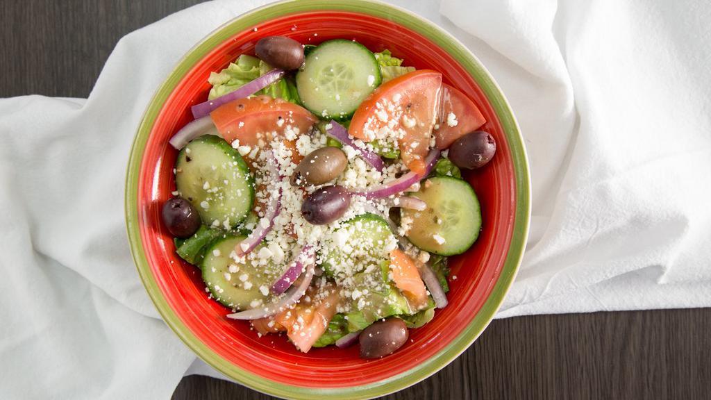 Greek Salad · A mixture of romaine lettuce, red onions, tomatoes, cucumber, and kalamata olives tossed in our house-blend vinaigrette greek. Dressing, topped with crumbled feta cheese.