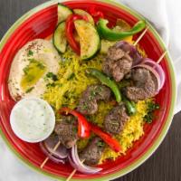 Kabobs · Skewers of charbroiled tender chicken, beef or  lamb, served with veggies and our special sa...