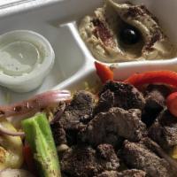 Shawarma Plate · Marinated chicken, beef, or lamb grilled to perfection and topped with onions, tomatoes, and...