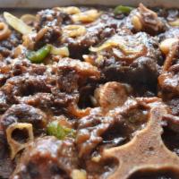 Oxtails · - Tender, braised oxtail, spiced with special Caribbean seasonings in a rich brown stew gravy.