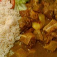 Curry Goat · Tender goat meat, spiced with Judy’s Caribbean seasonings in a rich, golden curry gravy.