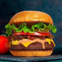 Natural Classic Burger · Beyond Meat patty topped with melted vegan cheddar cheese, grilled onions, mustard, house sp...