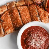 Rollino · Pepperoni, basil & mozzarella rolled into a golden crust. Served with marinara. (cal 880)
