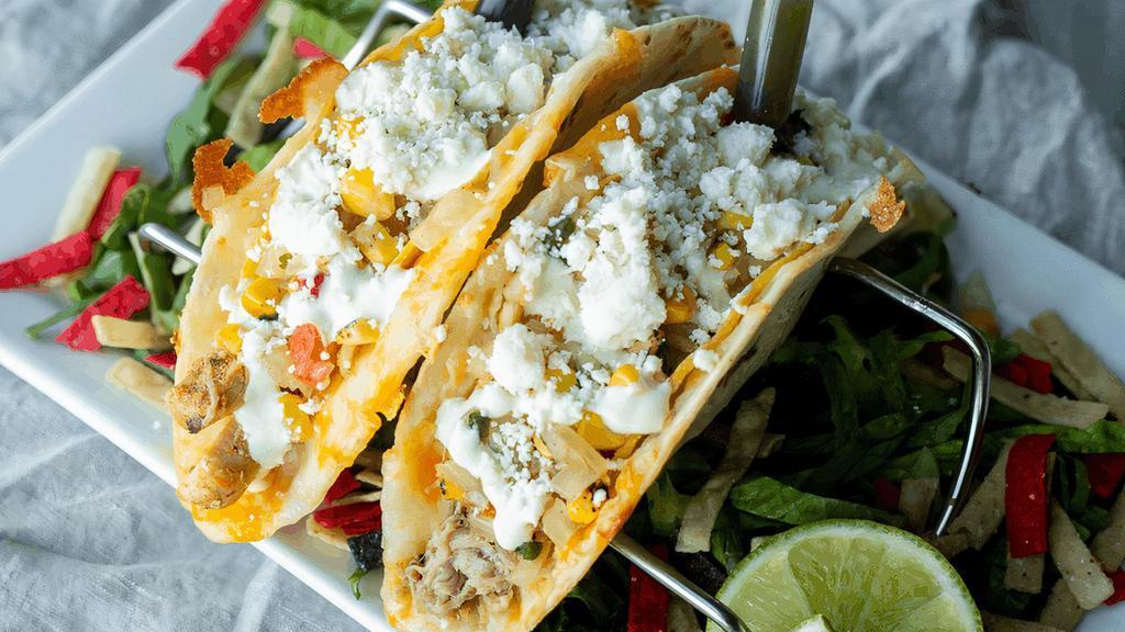 Street Taco Duo · Two crispy corn tacos, a pork carnitas & a southwest chicken, encased in a cheesy flour tortilla. Each topped with southwest relish & green chile sour cream, served with two house specialty hot sauces. (cal 930)