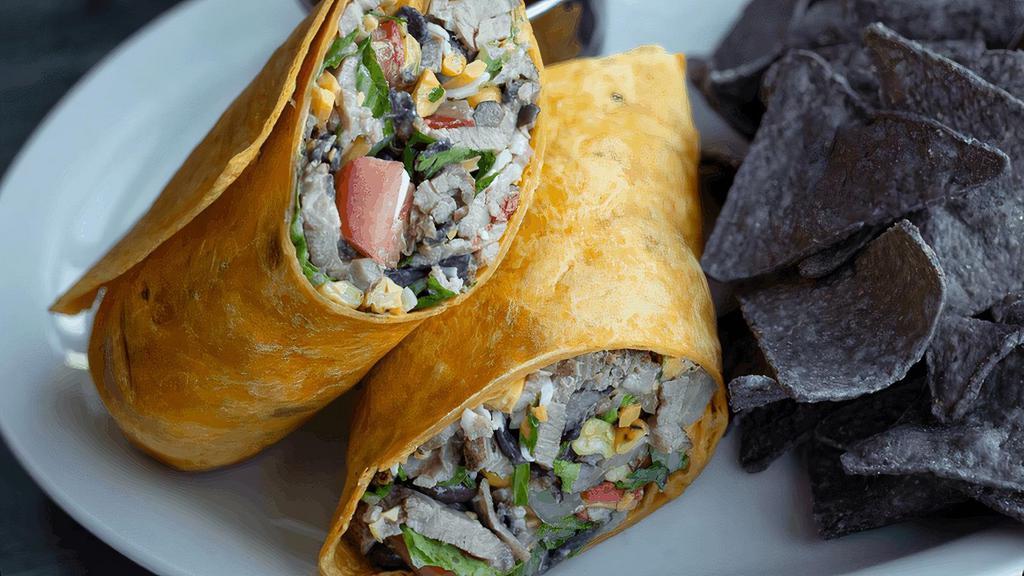 Sonoran Wrap · Grilled flank steak, tomatoes, charred corn medley, jack & cheddar cheeses, chopped romaine, tortilla strips, cilantro & southwest ranch in a jalapeño cheese wrap. Served with blue tortilla chips. (cal 1320)
