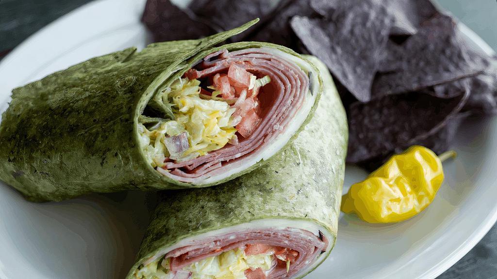 Big Bomber Wrap · 8 SERVINGS. Black forest ham, spicy capicola, Genoa salami, aged provolone, shredded lettuce, tomatoes, pepperoncinis, red onions & creamy vinaigrette in a spinach wrap. (cal 630/serving)