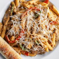 Cajun Chicken Alfredo · Seasoned chicken, spicy sausage & bell peppers, tossed with penne in our spicy Cajun cream s...