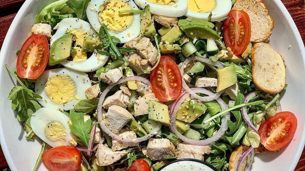 Cobb Salad · Garden greens, grilled chicken, avocado, bacon, hard-boiled egg, bleu cheese, cucumber, tomato.