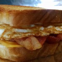 Buenos Dias · (2) fried eggs, American cheese, and bacon on buttered, toasted white bread.
