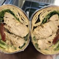 Grilled Chicken · Grilled chicken with hummus, lettuce, tomato and tahini dressing.