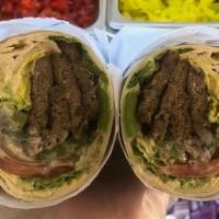 Gyro Kabab · Beef gyro, hummus, lettuce, tomato, grilled onions and peppers and tahini dressing.