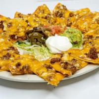 Tx Style Nachos -  Large · Crispy tostadas covered with refried beans, your choice of ground beef or grilled chicken, m...