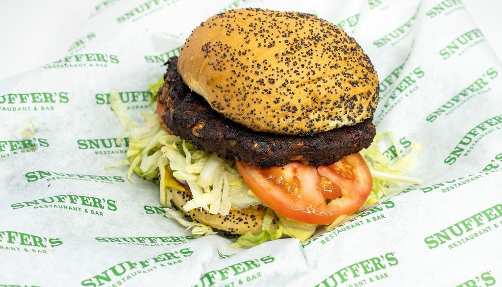 Black Bean Burger · A savory blend of black beans, brown rice, corn, diced tomatoes, green & red peppers with mustard, pickles, red onions, lettuce and tomatoes.