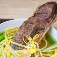 Big Beef Bone Soup (왕갈비탕) · Simmered beef short-ribs bone, vegetables, and sweet potato noodles.