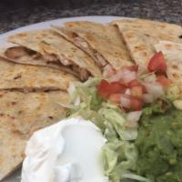 Grilled Chicken Quesadilla · Grilled flour tortilla stuffed with charbroiled chicken and jack cheese garnish with tomatoe...