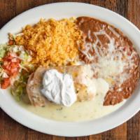 El Paso Chimichanga · Choose of chicken ground beef or picadillo deep fried and covered with chile con queso and s...