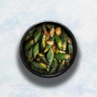 Bhindi Masala · Freshly cut okras sautéed with onions, tomatoes and herbs. Served with a portion of aromatic...