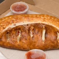 Calzone · Fresh baked pizza dough rolled around Ricotta,
Mozzarella cheeses & our special tomato
sauce.